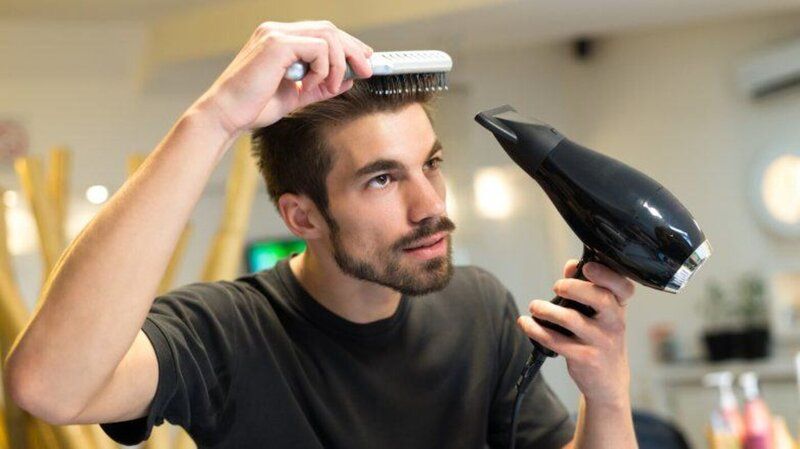 Homem secando o cabelo